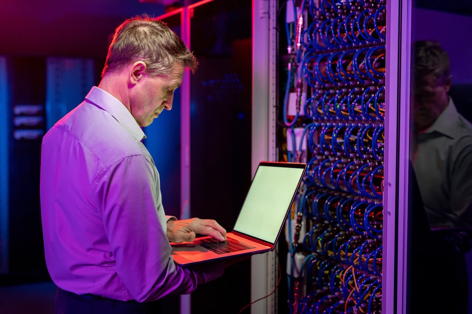 guy carefully checks data center for flaws